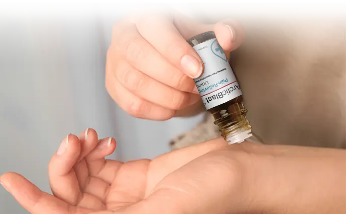 Drops of Arctic Blast being tipped from the bottle into an open palm.